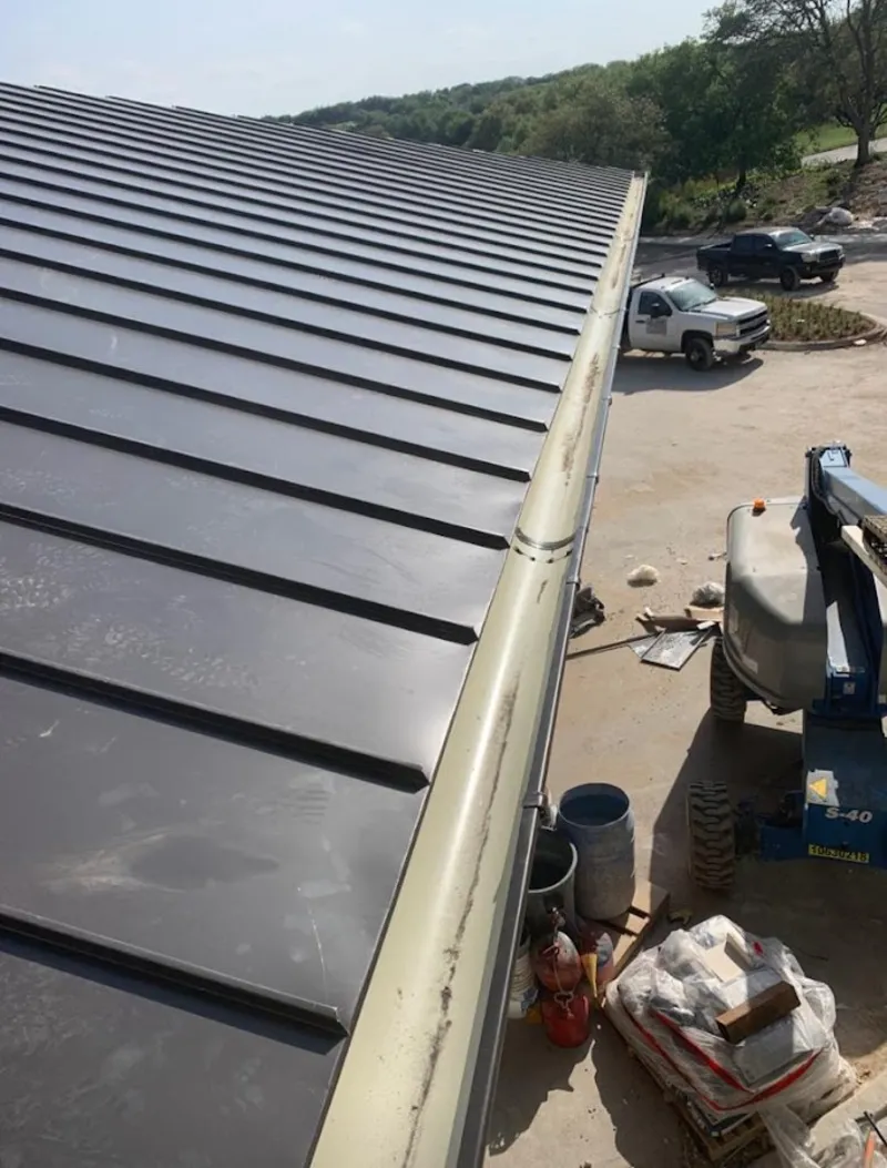 Standing seam panel and gutter detail on a metal roofing jobsite in North Merritt Island